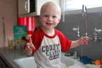 dsc_1748.jpg Devin saw the running water in the sink, and had to jump in