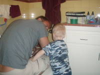 069.JPG Uncle Keith tries to fix Devin's bathtub drain