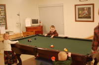 dsc_4353.jpg At the Patterson's party, the kids make use of the pool table.