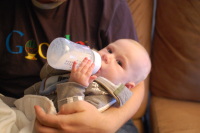 dsc_0067.jpg Devin holds the milk bottle himself for the first time!
